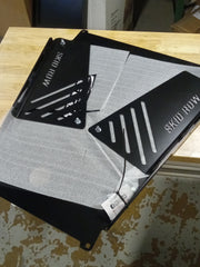 Load image into Gallery viewer, This image shows how the converter shields are mounted to the skid plate for shipping. 
