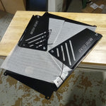 Load image into Gallery viewer, This image shows how the converter shields are mounted to the skid plate for shipping. 
