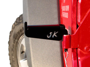 Front driver's side door foot peg mounted on the Jeep Wrangler JK with logo