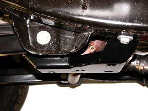 Side view of the exhaust loop skid plate next to the control arm where it mounts